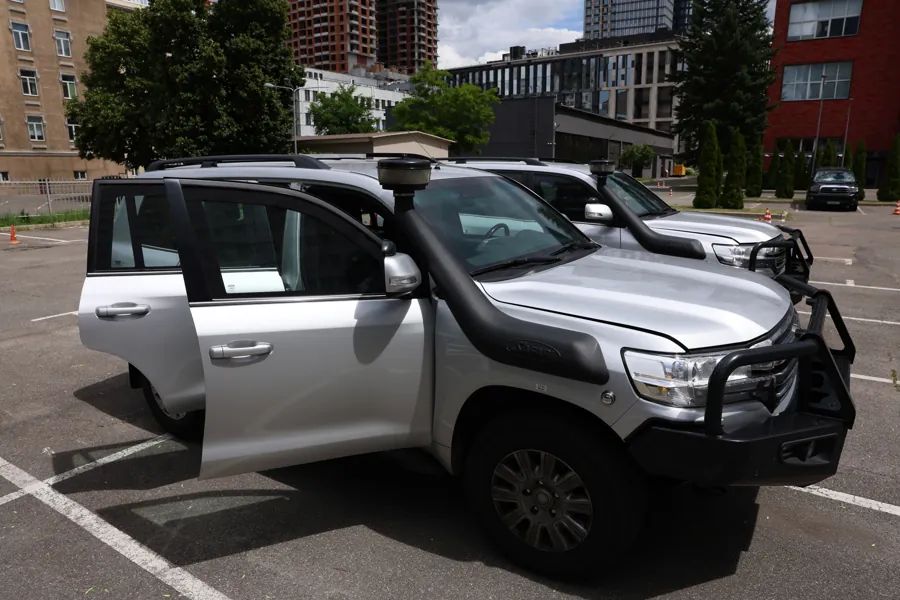 Armored SUV used by ARGUS for secure transport, doors open